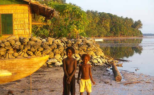 Young boys stand in front of the seawall at Han Island, which was built from clam shells recovered from a sunken poacher. Young boys stand in front of the seawall at Han Island, which was built from clam shells recovered from a sunken poacher.